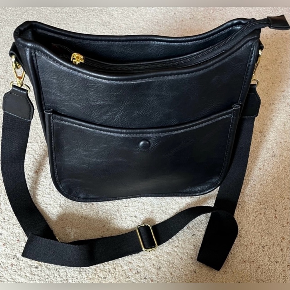 Black Leather Crossbody Bag with zipper closure and multi compartments. NWT.